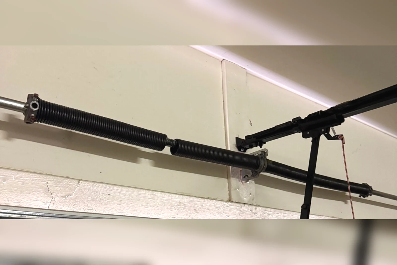 A Wayne Dalton garage door torsion spring system during a TorqueMaster repair in Phoenix, AZ
