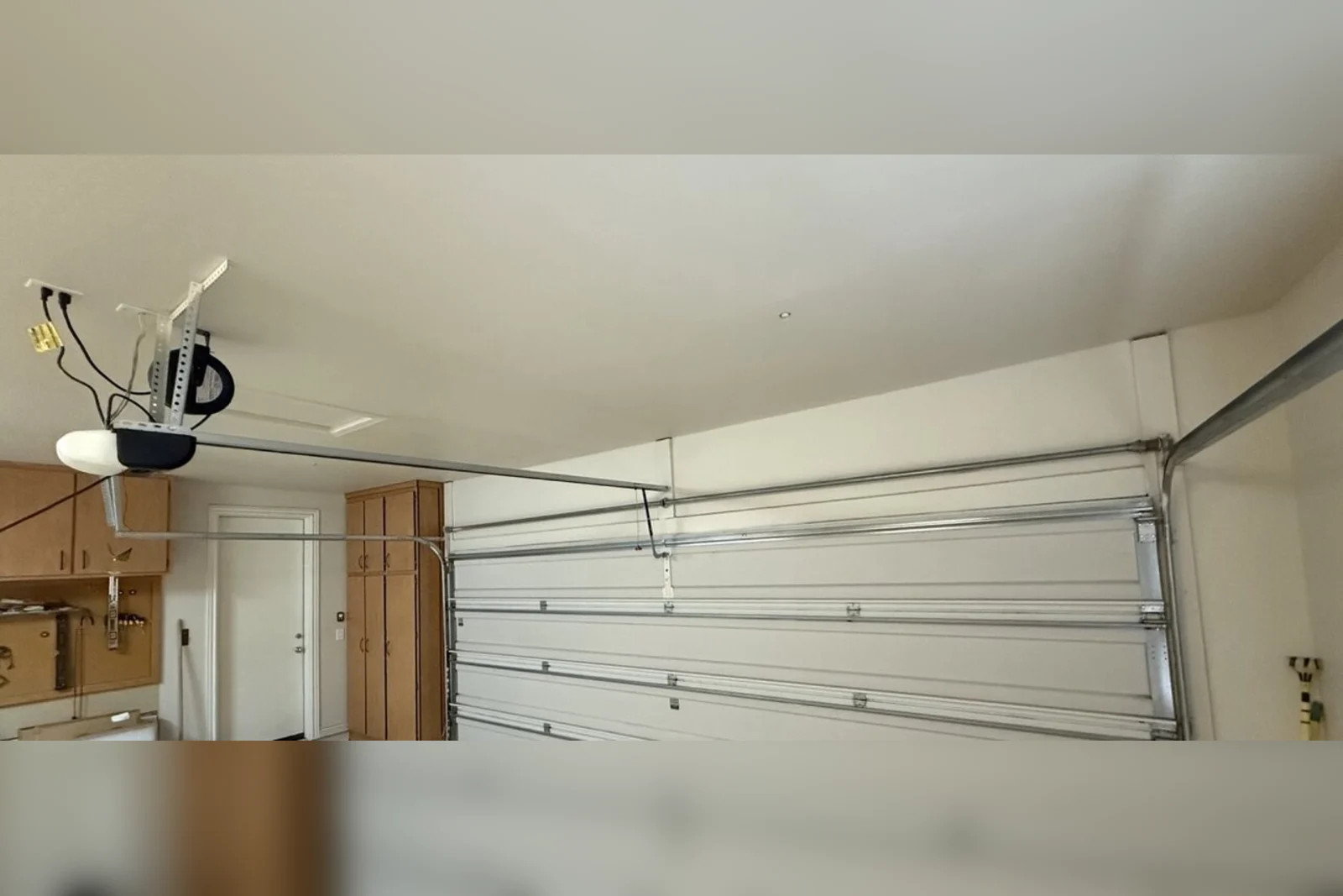 A Wayne Dalton TorqueMaster Plus system — the enclosed tube across the top of a garage door — in Phoenix, AZ