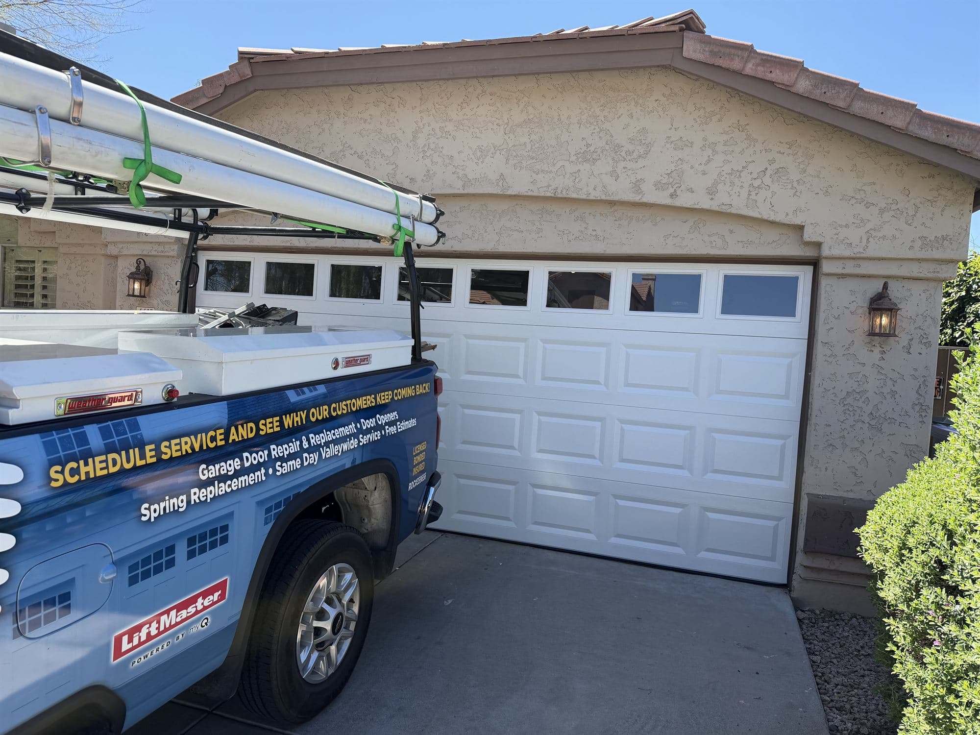 New white Clopay T50S garage door with windows installed after impact damage, Phoenix AZ