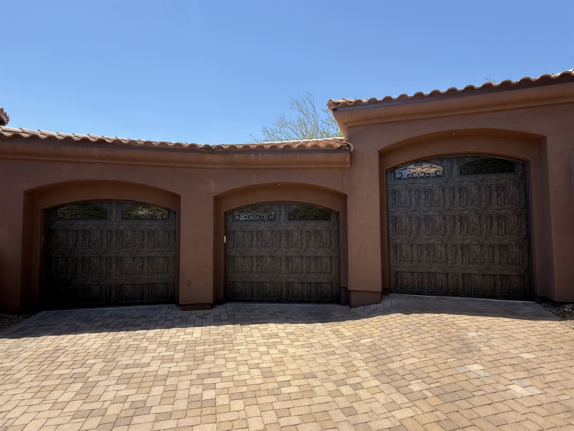 Wood-look carriage garage door installation in Fountain Hills, AZ by Desert Spring Garage Door Repair