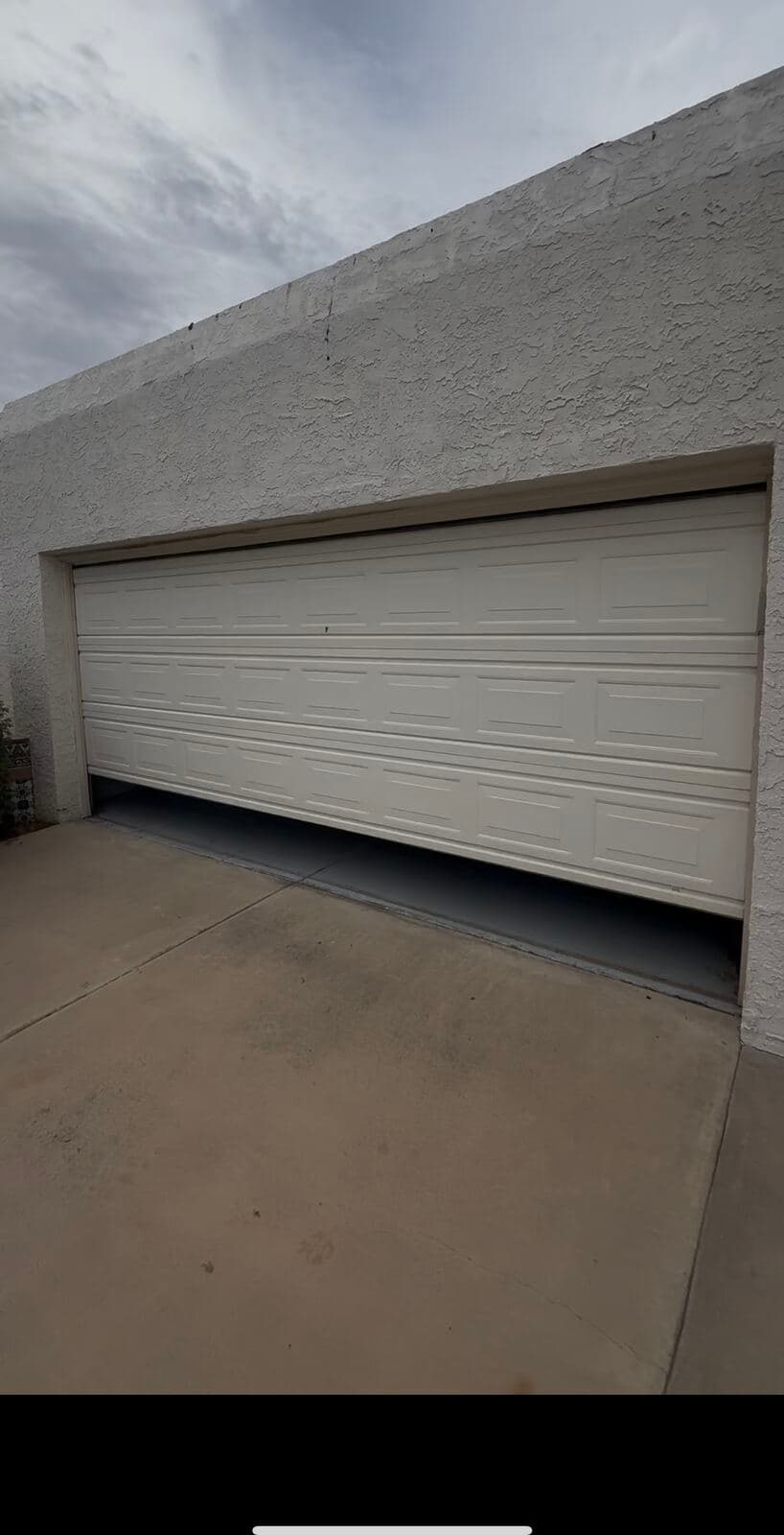 Old plain builder-grade raised-panel garage door before replacement on a Scottsdale, AZ home