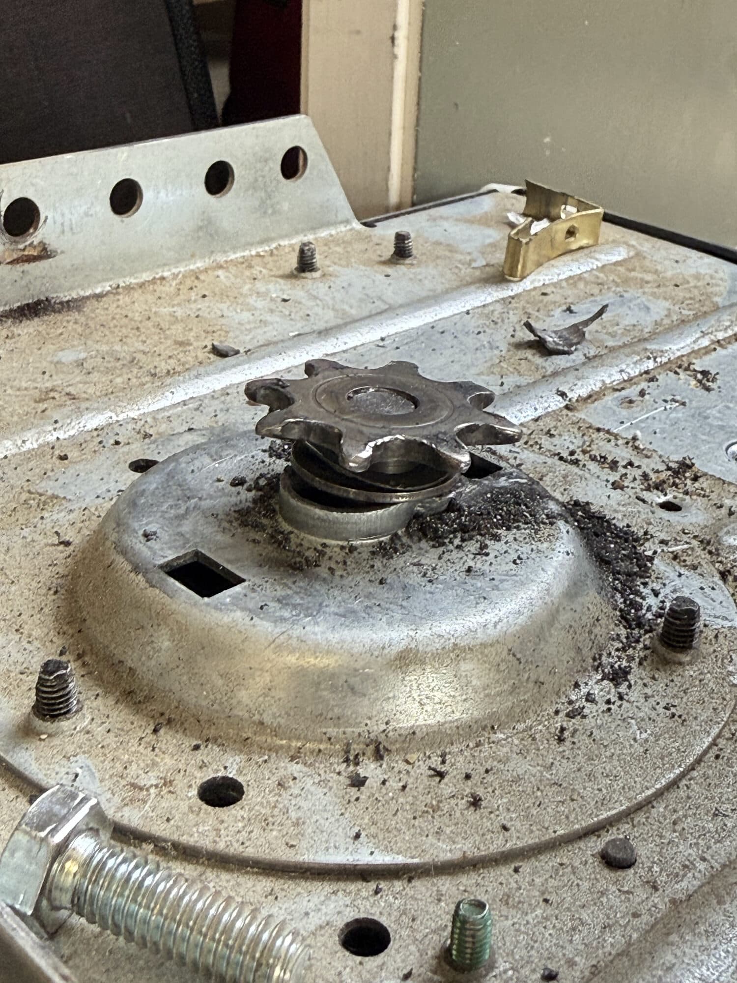 Old garage door opener motor with metal shavings on top from the strain of undersized springs, Phoenix AZ