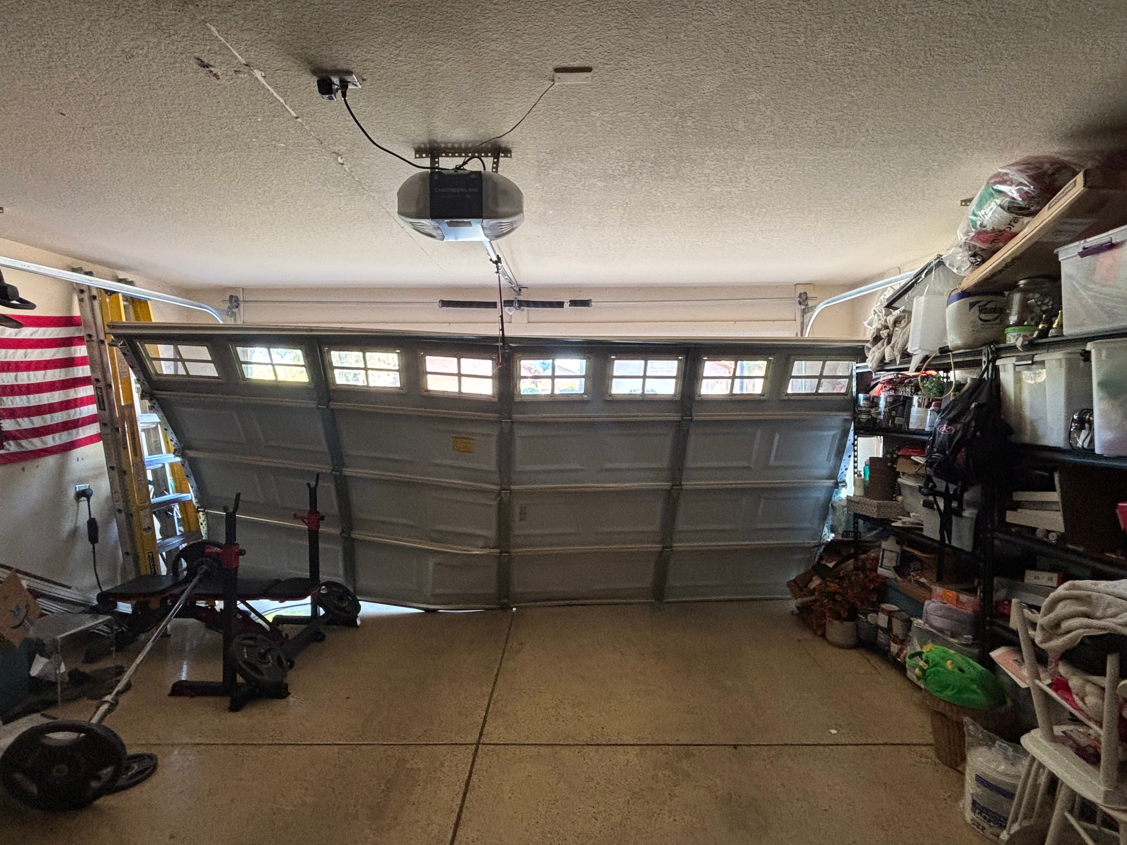 Desert Spring technician repairing a garage door track and rollers