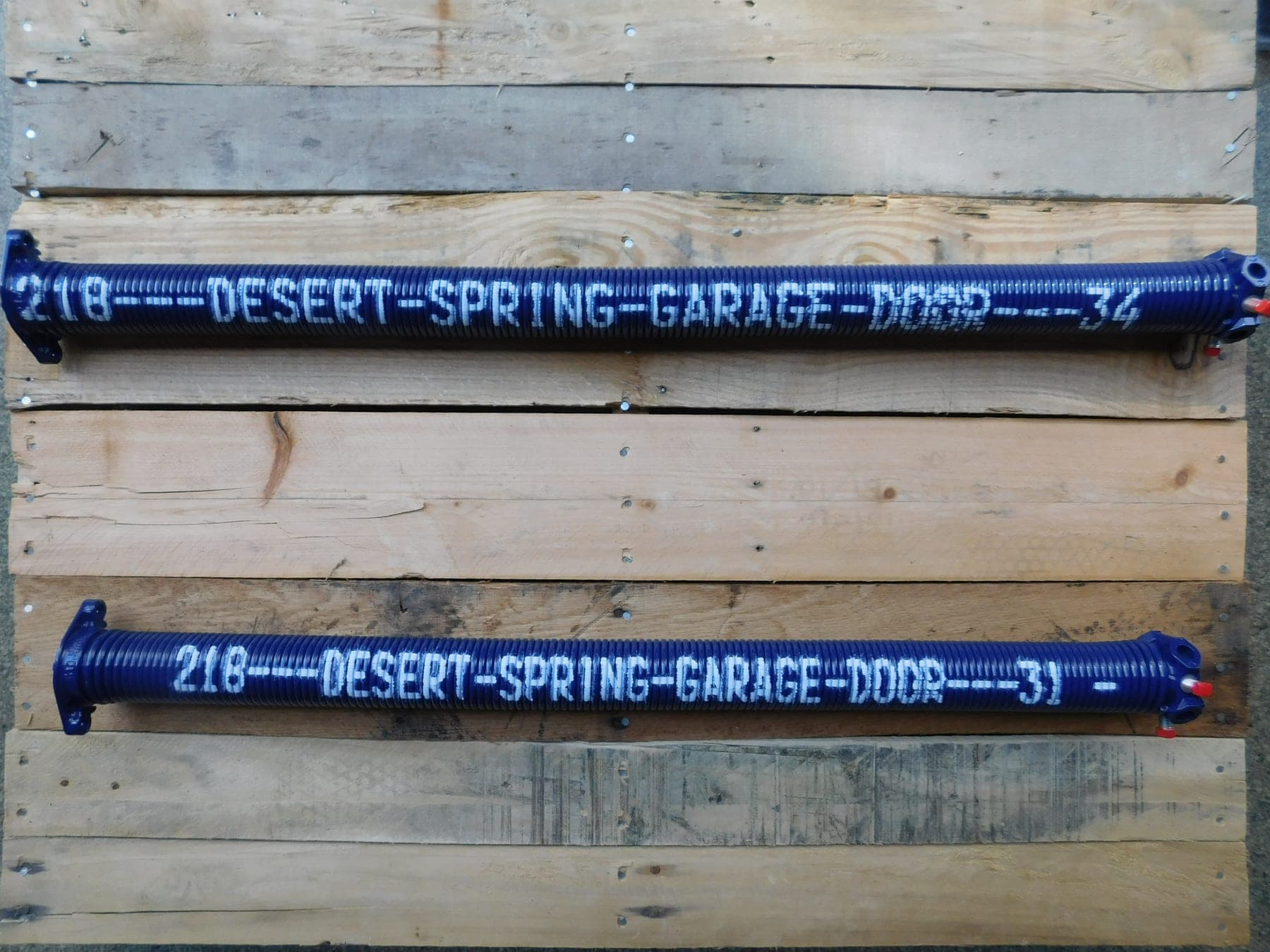 Two custom cobalt Desert Spring Performance Springs, stenciled with the Desert Spring name