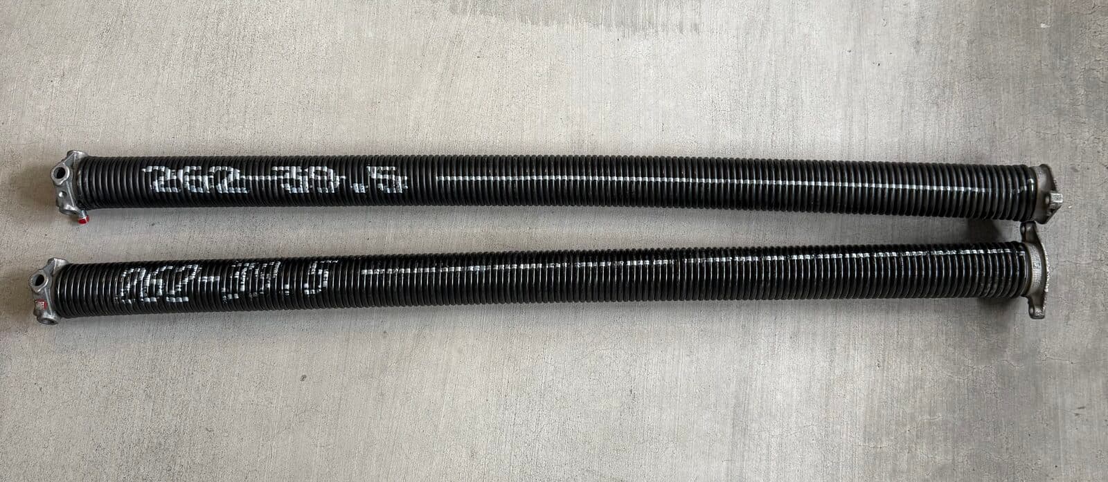 Two standard black oil-tempered garage door springs